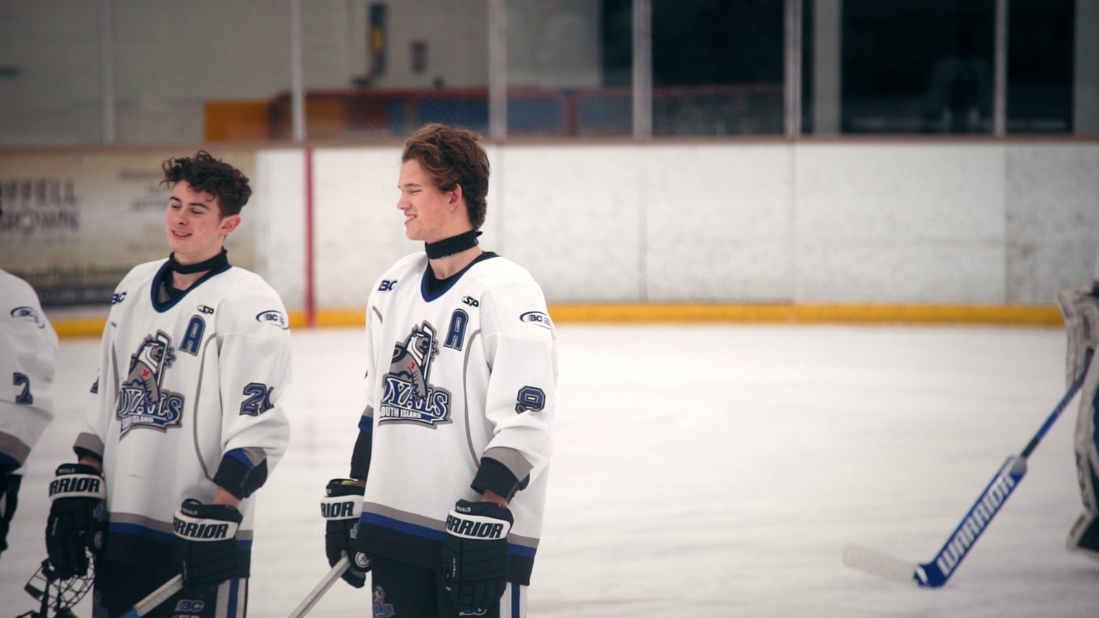 Two young players in white Nyals jerseys on the ice